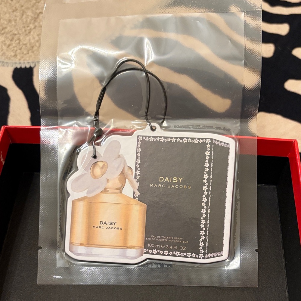 Marc Jacobs Daisy Gold and White Air Freshener. Use on a tight space or car.